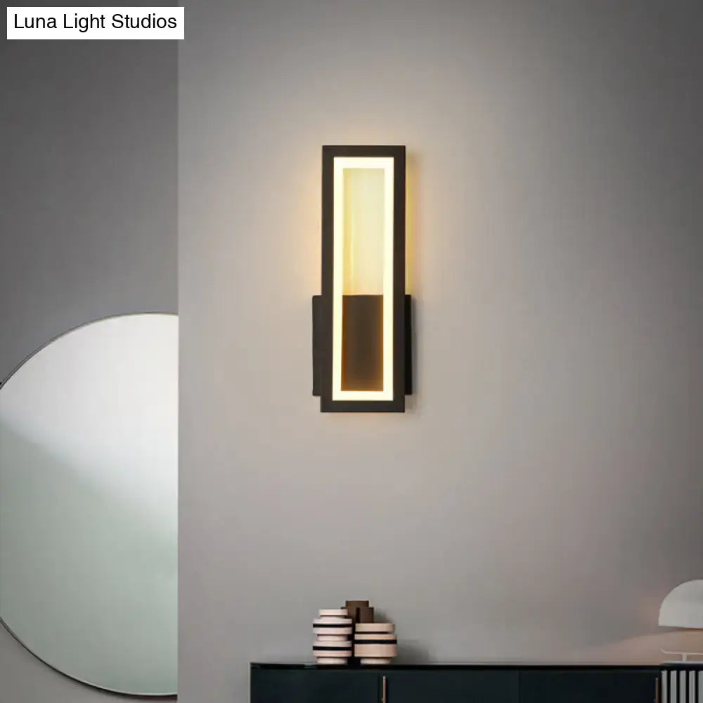 Decorbites black metal LED wall sconce with rectangular frame and warm foyer glow on Tampa Home & Garden Store