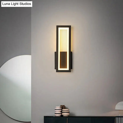 Decorbites black metal LED wall sconce with rectangular frame and warm foyer glow on Tampa Home & Garden Store