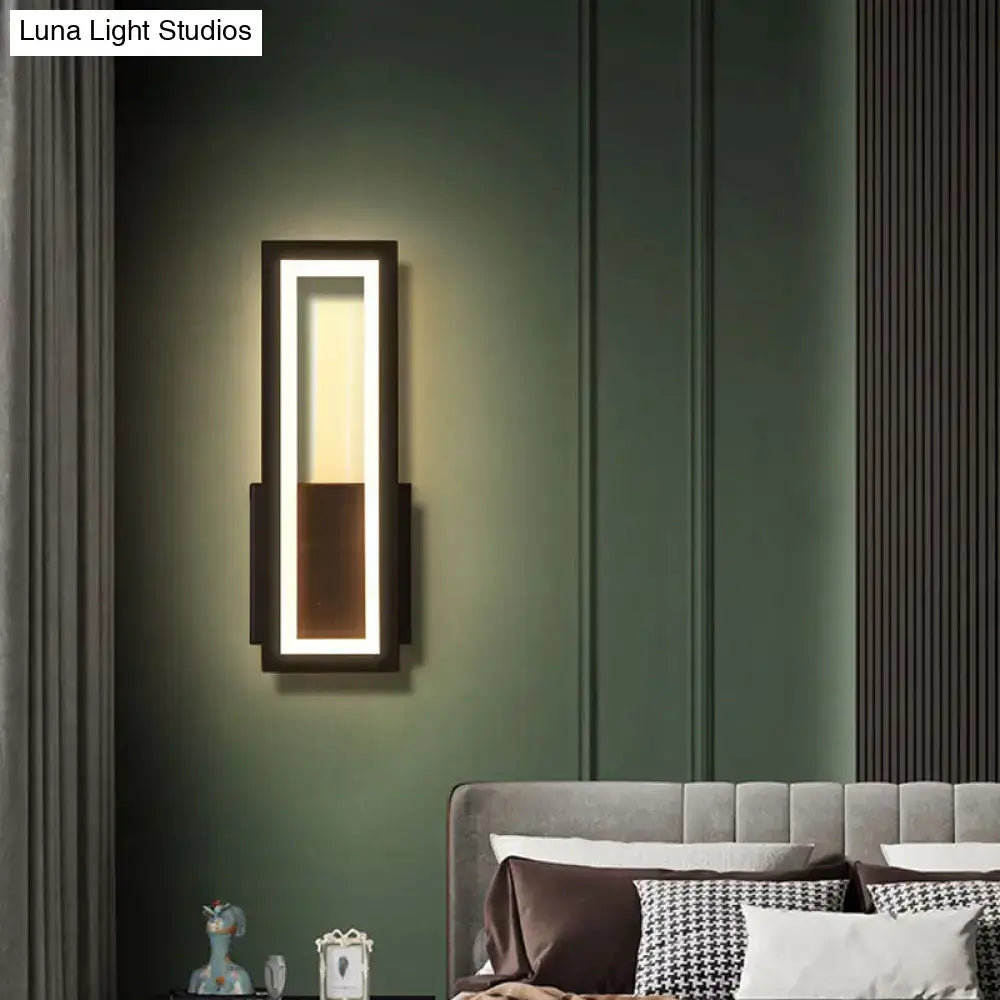 Black minimalist LED wall sconce with acrylic inner panel mounted beside the bed on green wall on Tampa Home & Garden Store