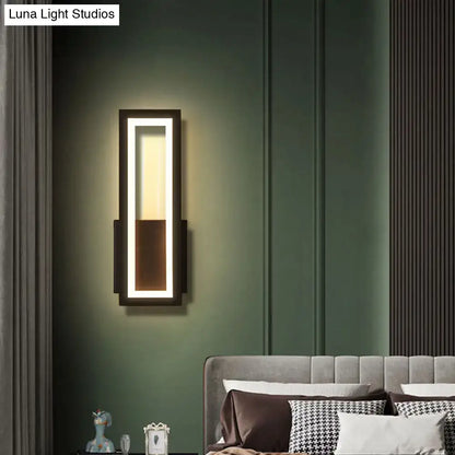Black minimalist LED wall sconce with acrylic inner panel mounted beside the bed on green wall on Tampa Home & Garden Store