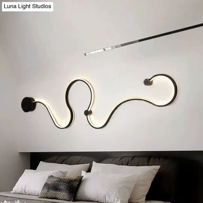 Modern black minimalist wall lamp sconce with curved LED strip delivering warm white light on Tampa Home & Garden Store