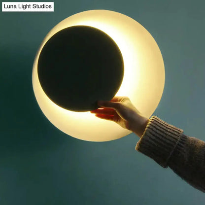 Modern circle sconce light by Decorbites with black center and warm halo for bedroom wall on Tampa Home & Garden Store