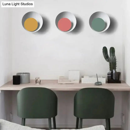 Three modern circle sconce lights with black outer rings and colored centers by Decorbites on Tampa Home & Garden Store