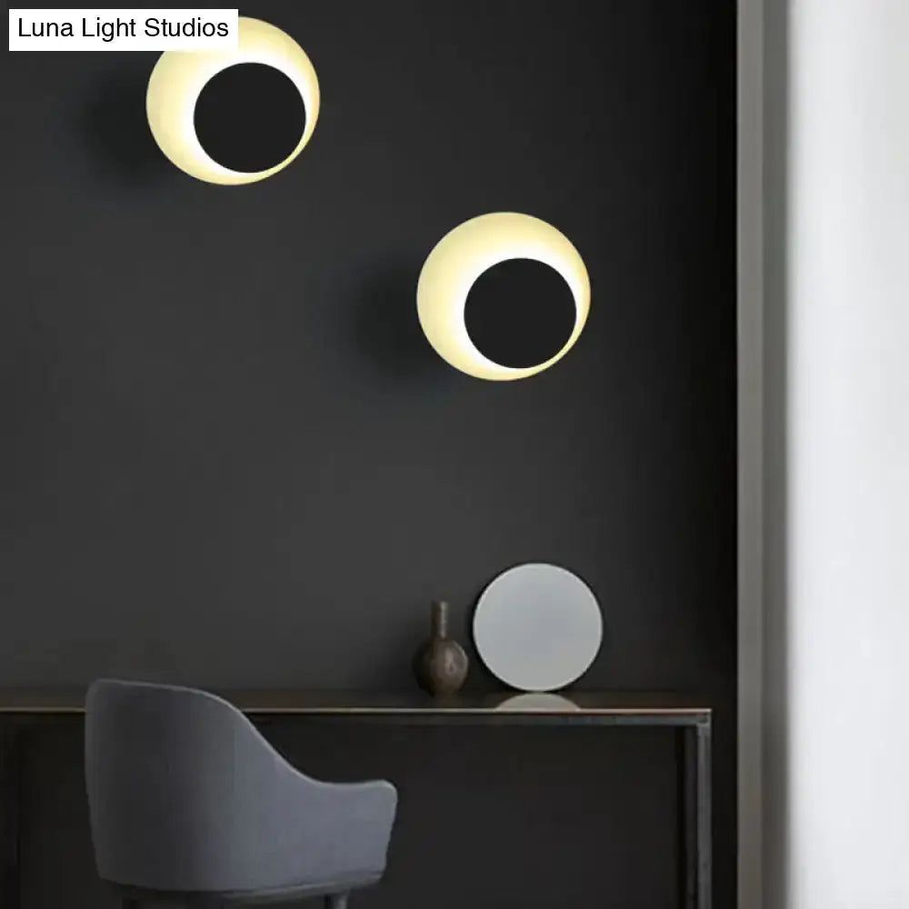 Modern dual circle LED wall sconce lights with warm glow on dark wall in bedroom on Tampa Home & Garden Store