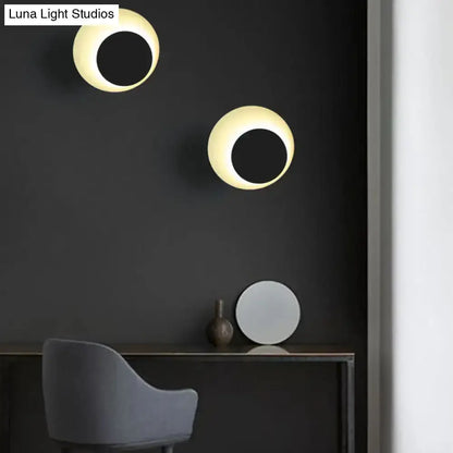 Modern dual circle LED wall sconce lights with warm glow on dark wall in bedroom on Tampa Home & Garden Store