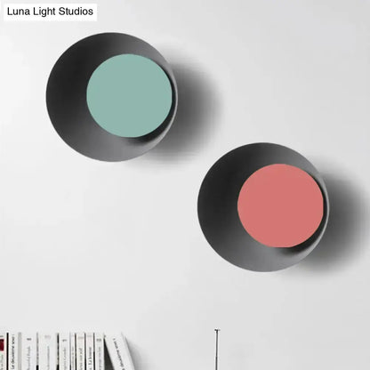 Pair of modern black circle sconces with teal and pink centers for bedroom wall decor on Tampa Home & Garden Store