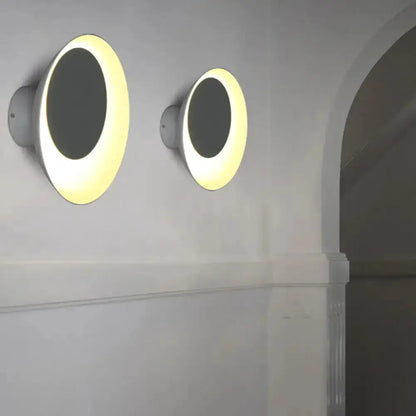 Two modern circular wall sconces with illuminated white rings for bedroom decor on Tampa Home & Garden Store