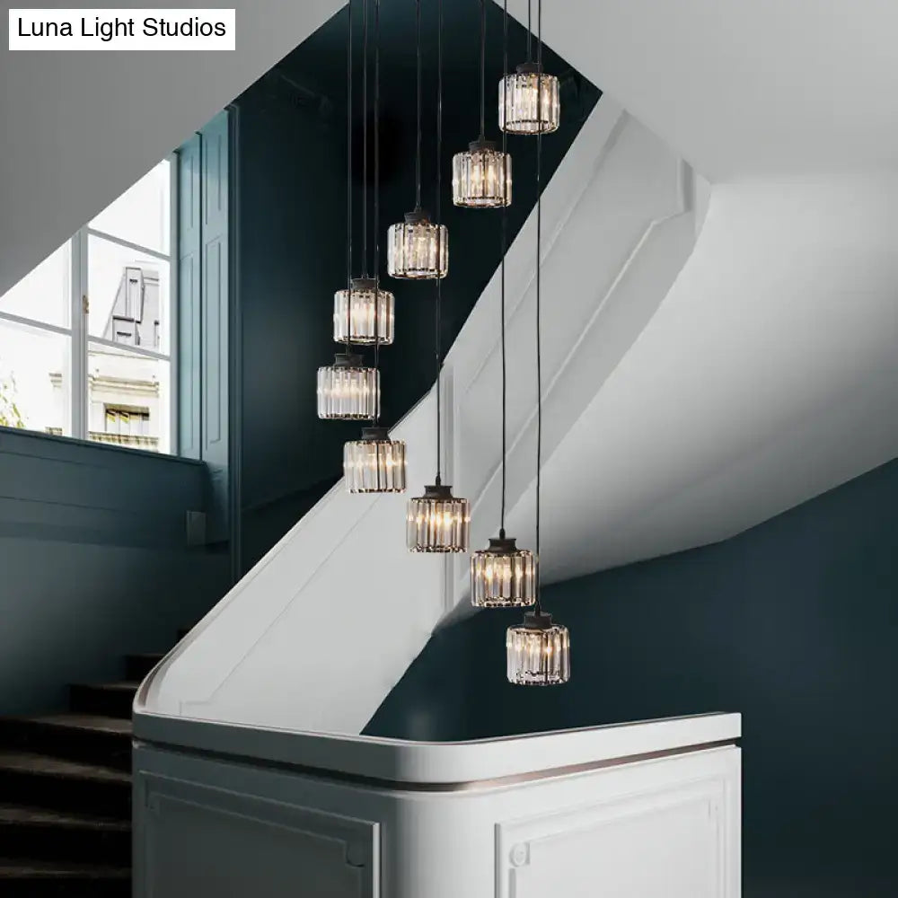 Black crystal cylindrical stairway pendant lights by Decorbites over a white railing on Tampa Home & Garden Store