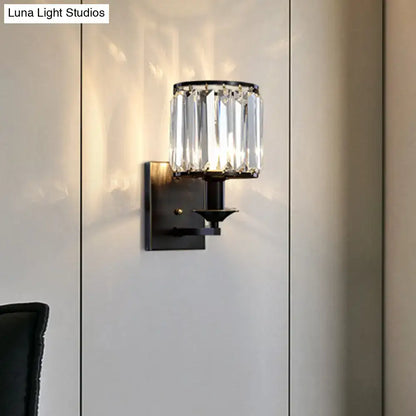 Black crystal cylindrical wall sconce by Decorbites with clear prisms and black metal mount on Tampa Home & Garden Store