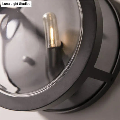 Black metal wall sconce with clear crystal shade and visible bulb on Tampa Home & Garden Store
