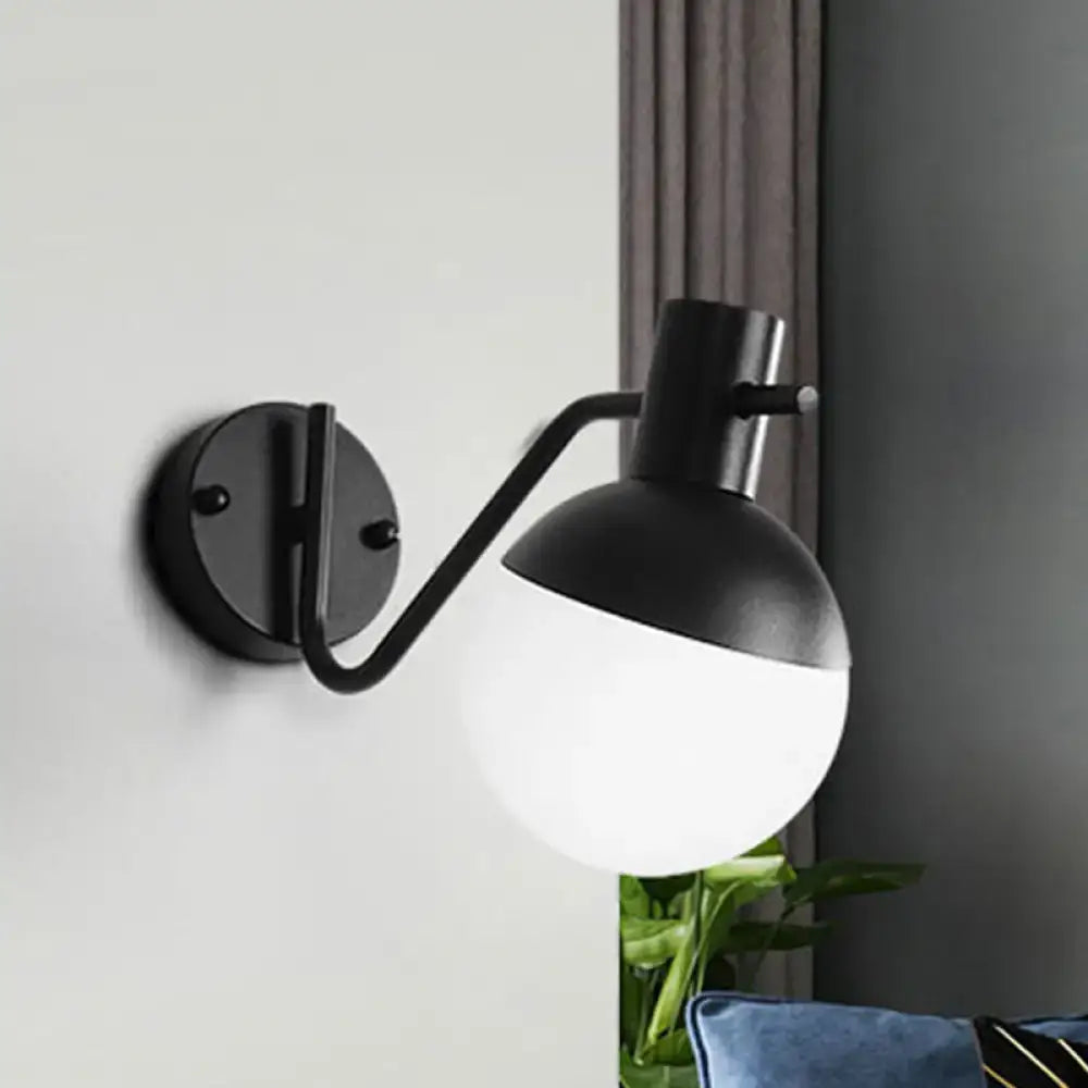 Black glass shade sconce by Decorbites with curved arm and round wall mount, two-tone globe on Tampa Home & Garden Store