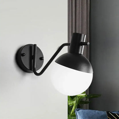 Black glass shade sconce by Decorbites with curved arm and round wall mount, two-tone globe on Tampa Home & Garden Store