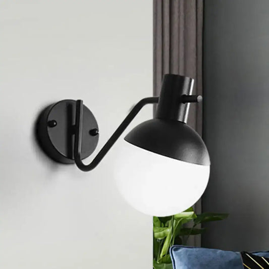 Black glass shade sconce by Decorbites with curved arm and round wall mount, two-tone globe on Tampa Home & Garden Store