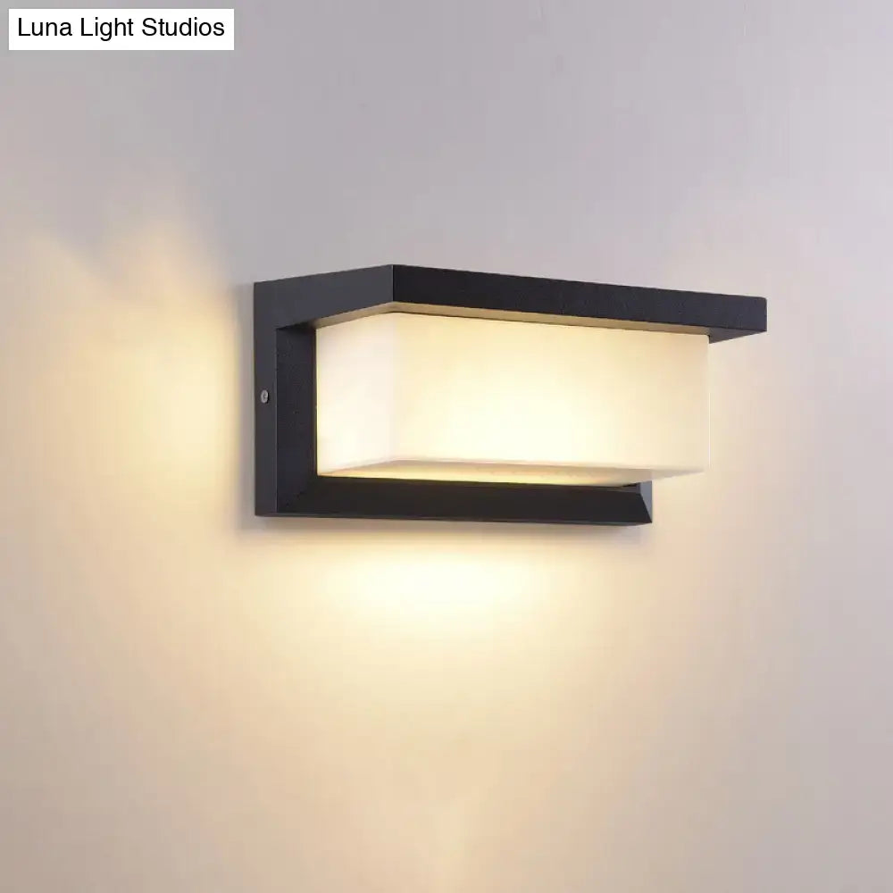 Black sound-activated sconce with rectangular metal frame and frosted shade on Tampa Home & Garden Store