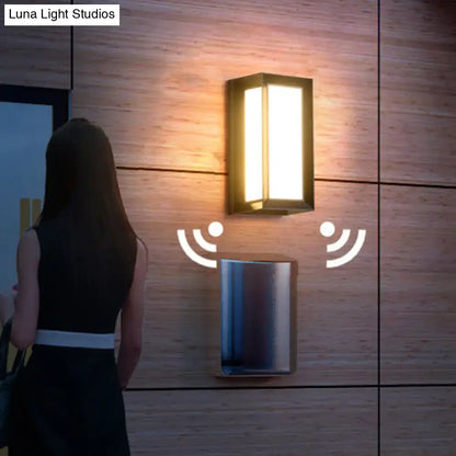 Black sound activated sconce, rectangular black wall light on wood paneling, single unit on Tampa Home & Garden Store