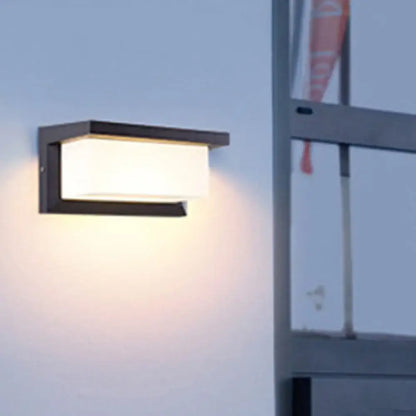 Black sound-activated sconce with white rectangular shade and black metal frame wall-mounted on Tampa Home & Garden Store