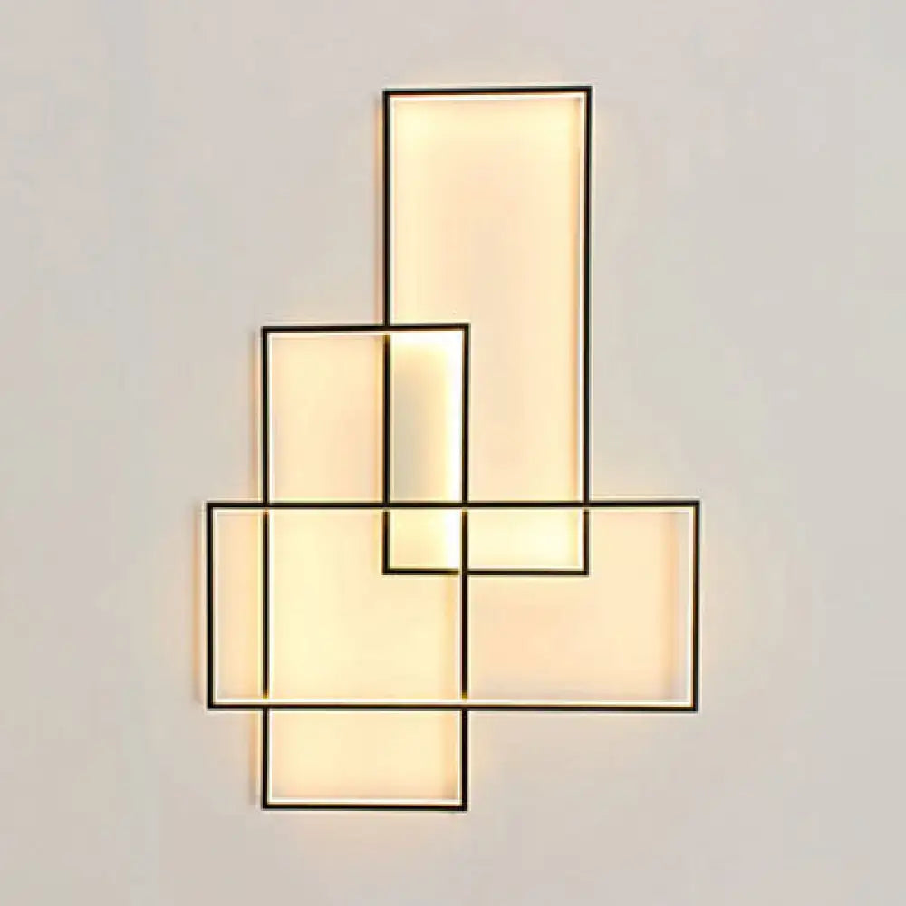 Black acrylic wall sconce Decorbites with stacked rectangular panels and warm backlit glow on Tampa Home & Garden Store
