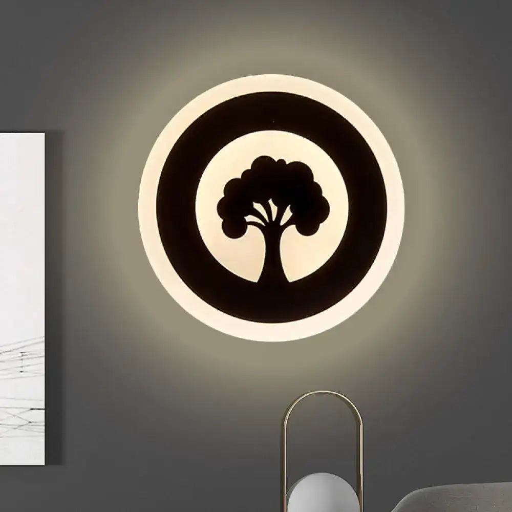 Black Pattern Wall Sconce with tree silhouette inside circular frame, subtle wall glow on Tampa Home & Garden Store