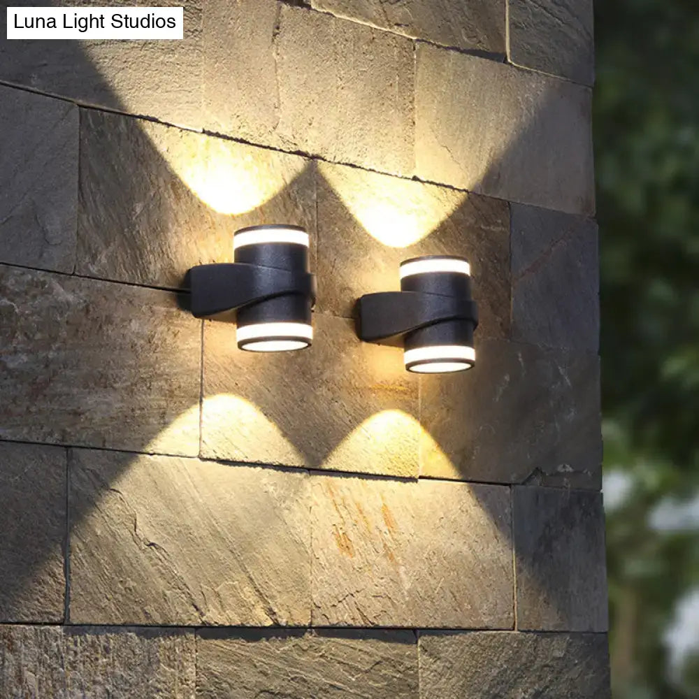 Black tubular wall sconce pair by Decorbites with wrap metal band on wall, warm white light on Tampa Home & Garden Store