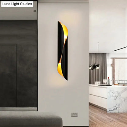 Black tubular wall lamp with gold inner accent, wall-mounted in a modern interior on Tampa Home & Garden Store