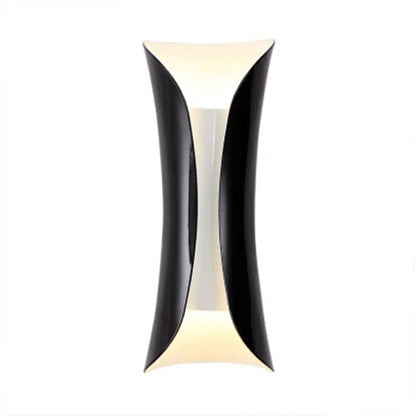 Black tubular wall lamp by Decorbites, modern curved black metal shade with warm glow on Tampa Home & Garden Store
