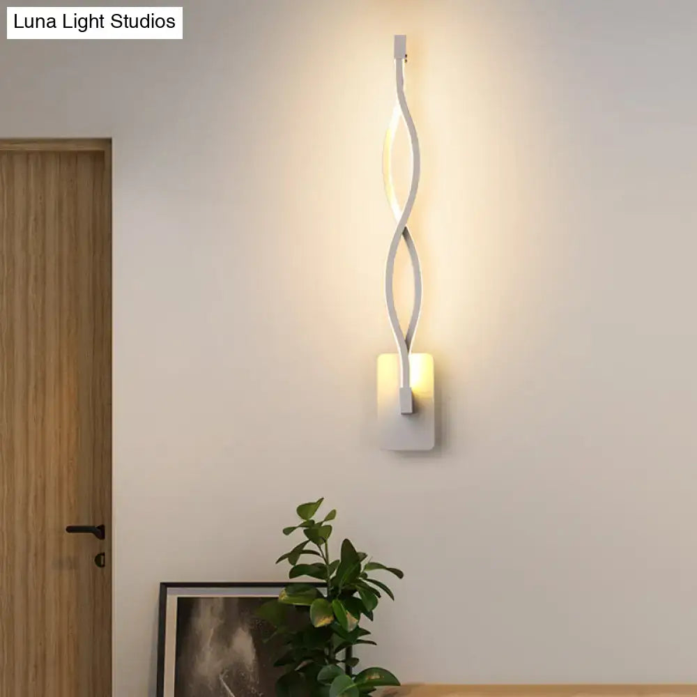 Black twisted LED sconce by Decorbites; double-helix wall light with warm glow on square mount on Tampa Home & Garden Store