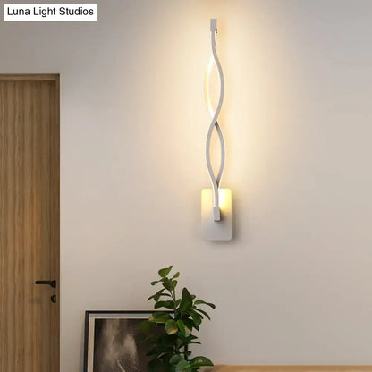 Black twisted LED sconce by Decorbites; double-helix wall light with warm glow on square mount on Tampa Home & Garden Store