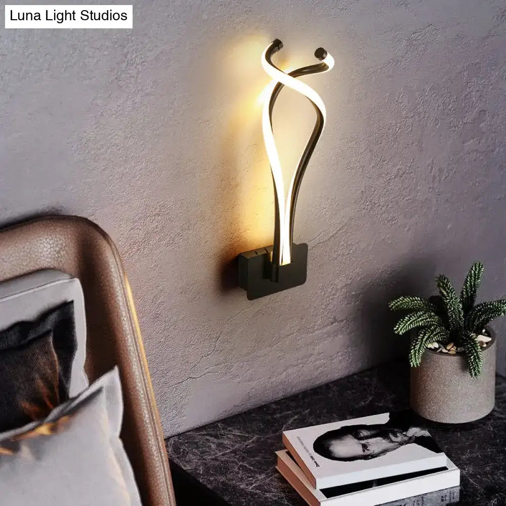 Black Spiral LED Sconce by Decorbites, wall mounted base with twisting LED loops, warm glow on Tampa Home & Garden Store