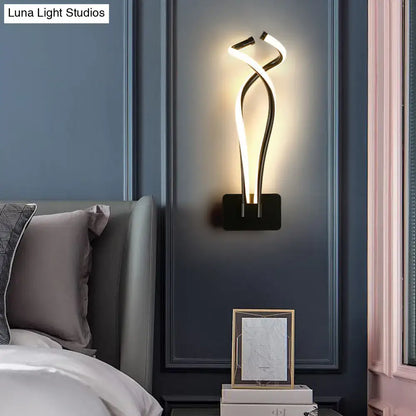 Decorbites Black Spiral LED wall sconce with intertwining glow tubes on dark blue wall on Tampa Home & Garden Store