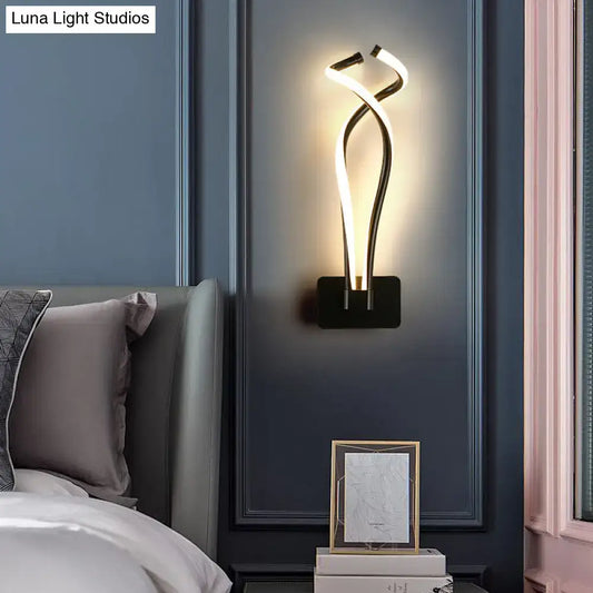 Decorbites Black Spiral LED wall sconce with intertwining glow tubes on dark blue wall on Tampa Home & Garden Store