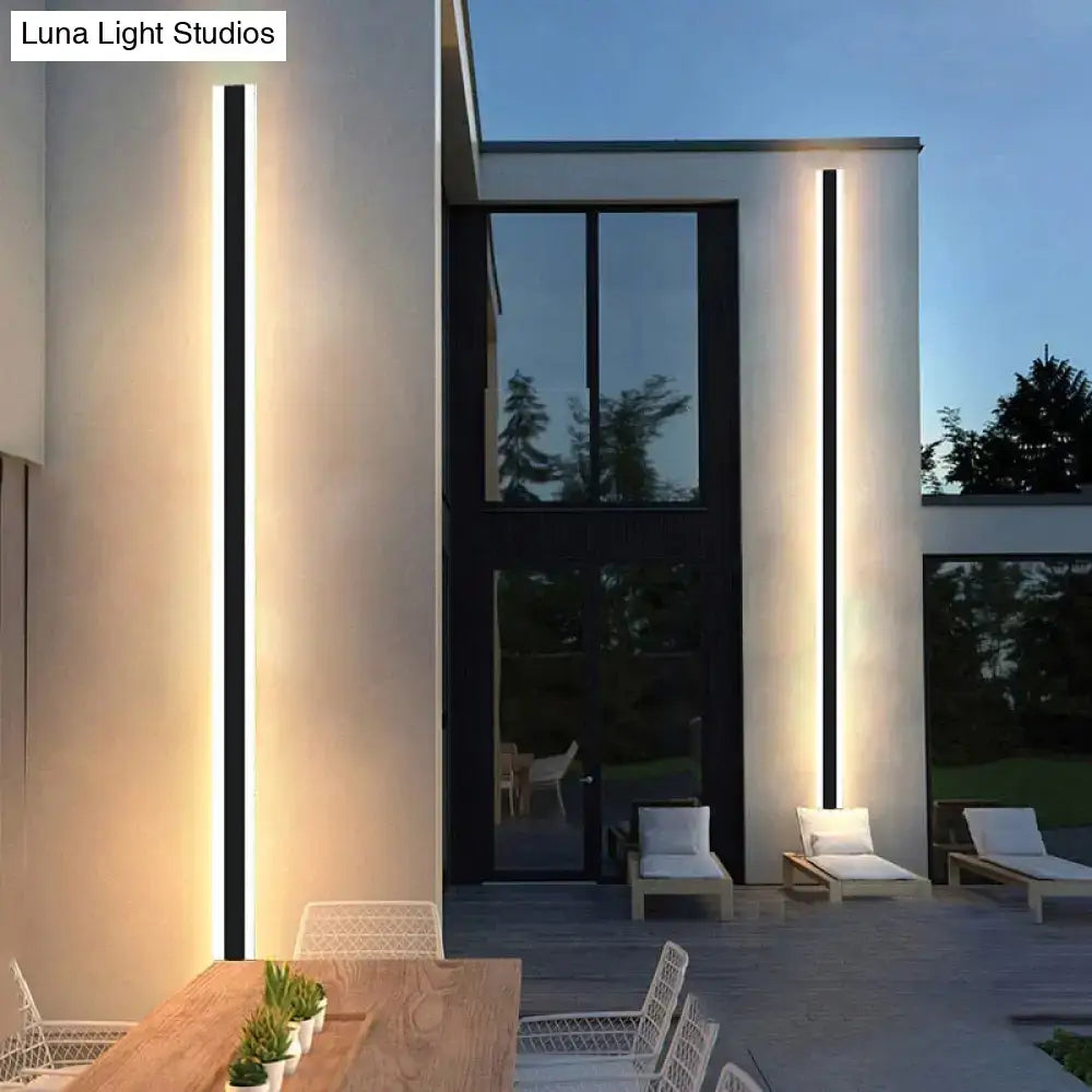 Modern black vertical LED wall sconce outdoor lighting, two IP65 Decorbites fixtures on facade on Tampa Home & Garden Store