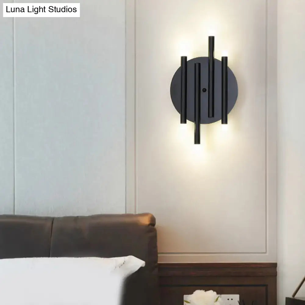 Black round wall sconce with vertical rods around a circular backplate, wall-mounted glow on Tampa Home & Garden Store