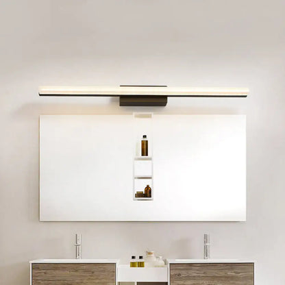 Black linear curved bar bathroom sconce over white vanity mirror, metal finish on Tampa Home & Garden Store