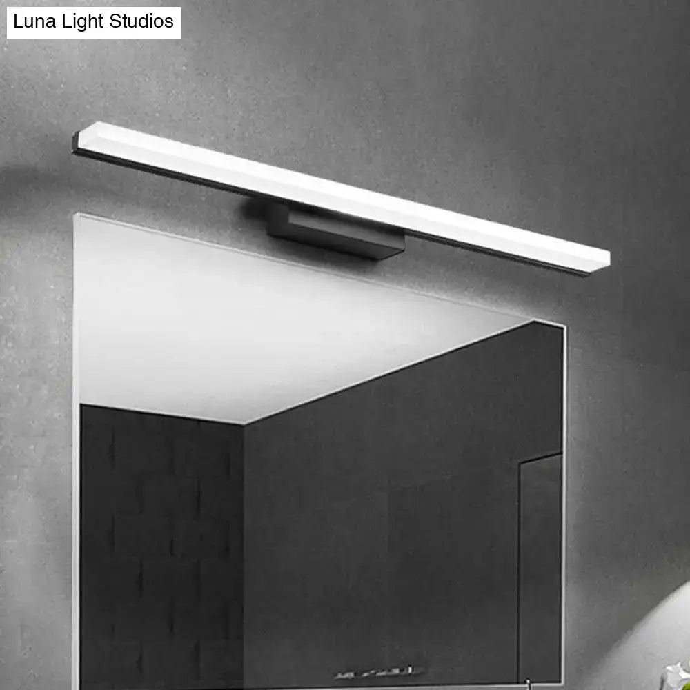 Black linear curved bar bathroom sconce by Decorbites above mirror on Tampa Home & Garden Store