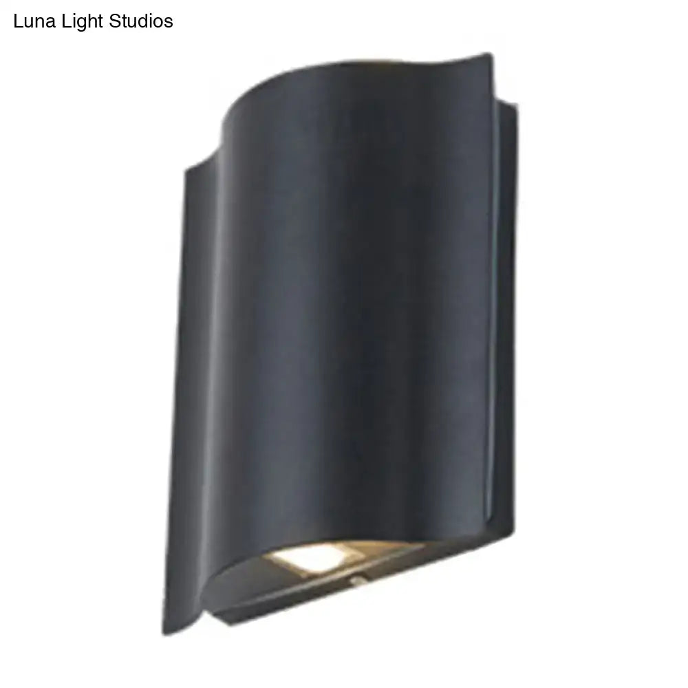 Decorbites black wavy wall sconce with downward light on Tampa Home & Garden Store