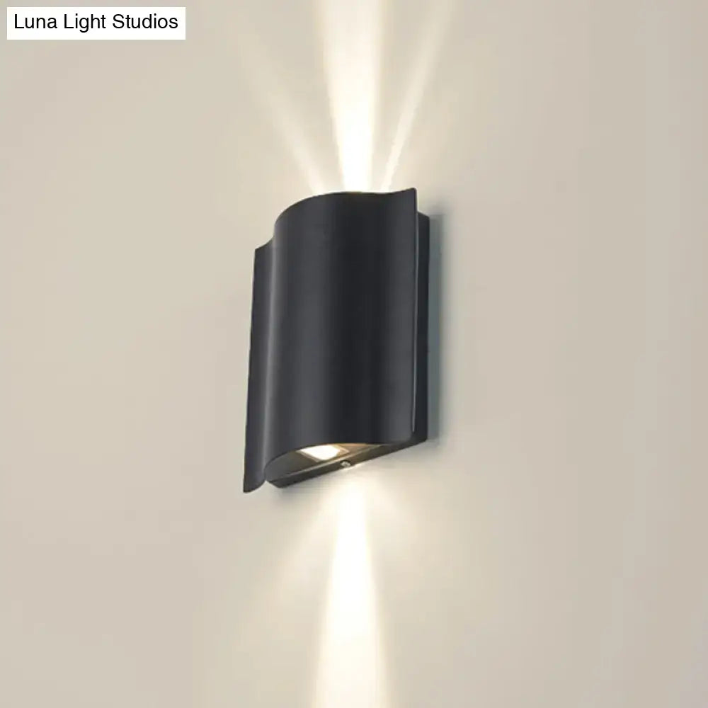 Black wavy wall sconce by Decorbites, curved black metal wall-mount with up/down light on Tampa Home & Garden Store