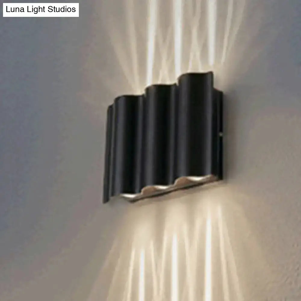 Black wavy wall sconce by Decorbites; black metal wall light with vertical ridges on Tampa Home & Garden Store