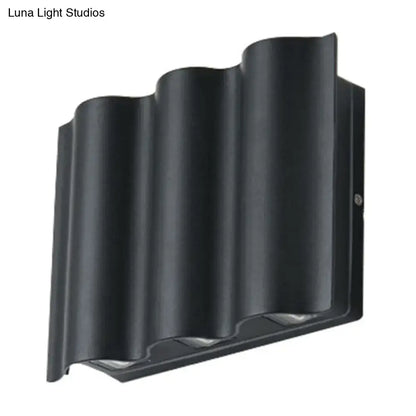 Black wavy wall sconce by Decorbites with ribbed metal shade on Tampa Home & Garden Store