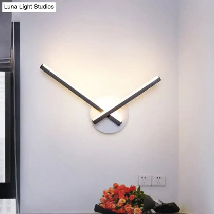 Decorbites modern black and white acrylic cross wall sconce with warm white light on Tampa Home & Garden Store