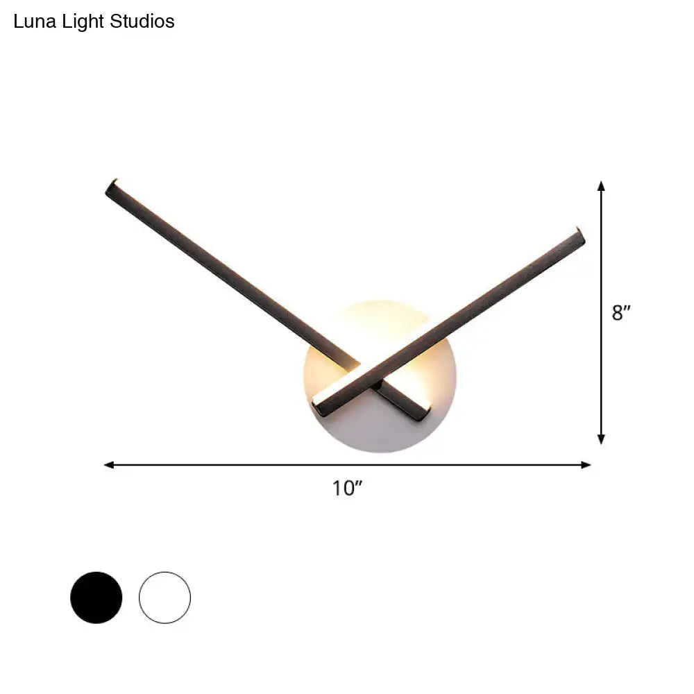 Modern black and white acrylic cross wall sconce with warm white light on Tampa Home & Garden Store