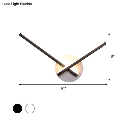 Modern black and white acrylic cross wall sconce with warm white light on Tampa Home & Garden Store