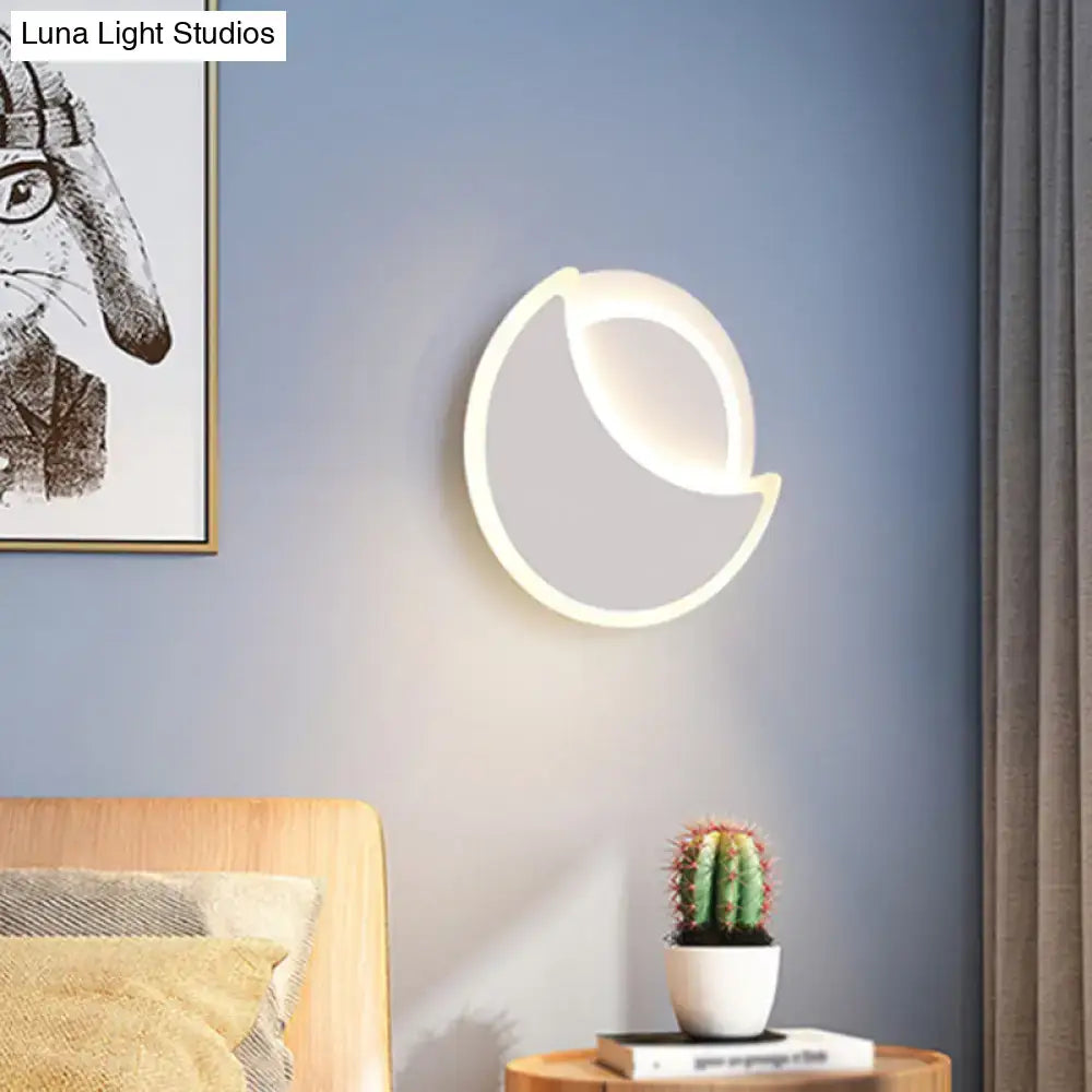 Decorbites White Eclipse Wall Sconce, crescent-shaped LED ring on blue wall on Tampa Home & Garden Store