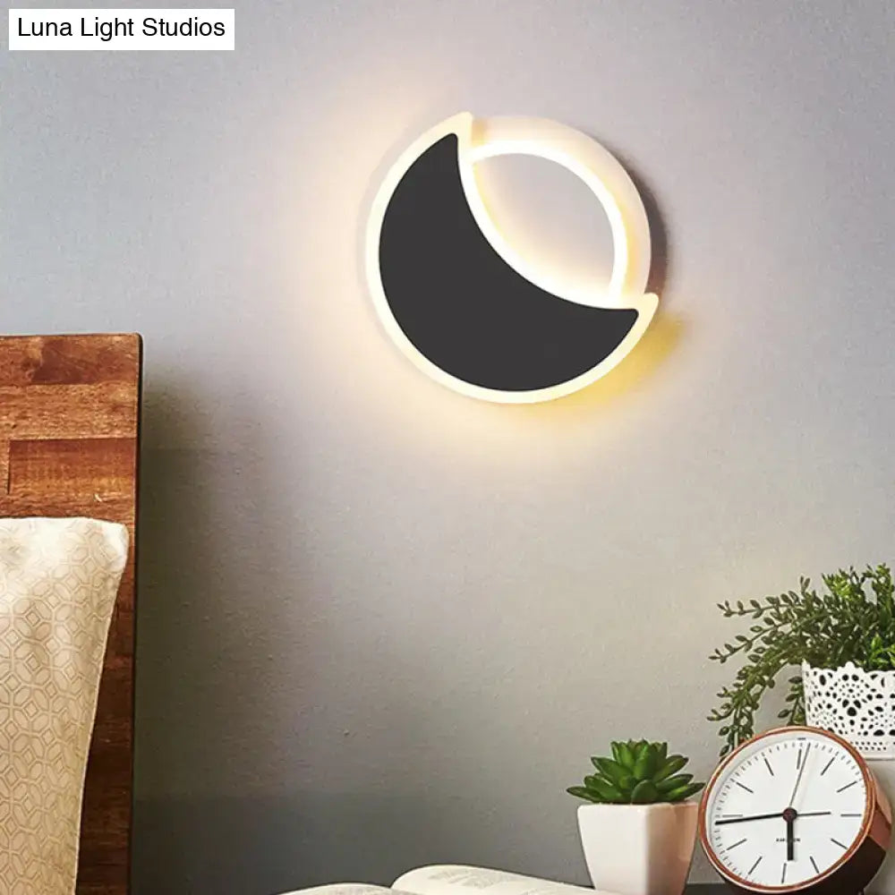 White Eclipse Wall Sconce by Decorbites, circular white frame with black crescent on Tampa Home & Garden Store