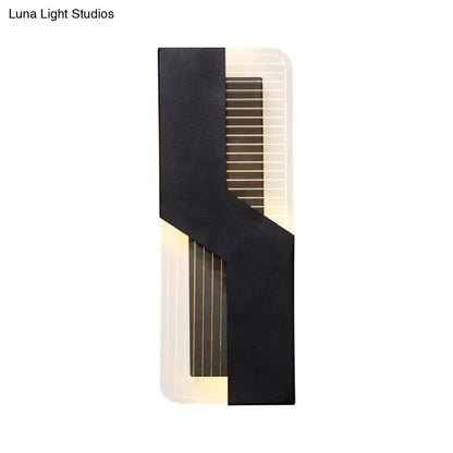 White angular wall sconce with a bold black strap over a ribbed backplate by Decorbites on Tampa Home & Garden Store