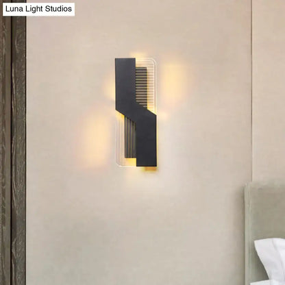White angular wall sconce by Decorbites with black geometric overlay and warm backlit glow on Tampa Home & Garden Store
