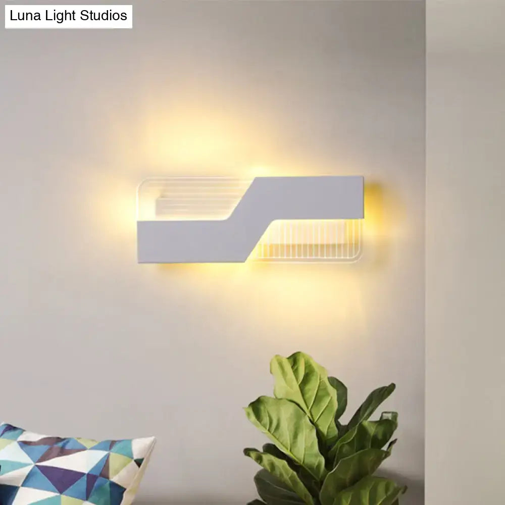 White angular wall sconce by Decorbites with geometric silhouette and warm ambient glow on Tampa Home & Garden Store
