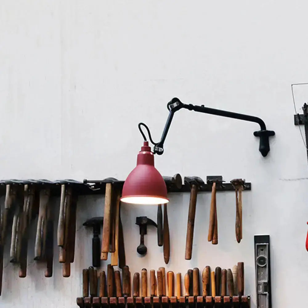 Red articulated wall lamp by Decorbites with adjustable arm mounted above a tool rack on a wall on Tampa Home & Garden Store