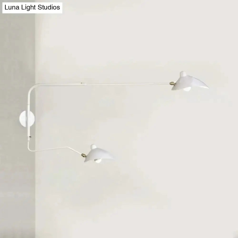 Modern black and white articulated wall sconce with dual white shades and brass joints on wall on Tampa Home & Garden Store