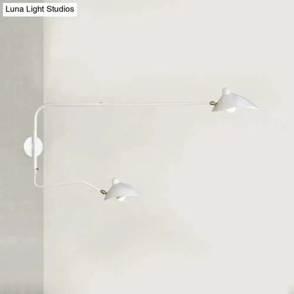 Modern black and white articulated wall sconce with dual white shades and brass joints on wall on Tampa Home & Garden Store