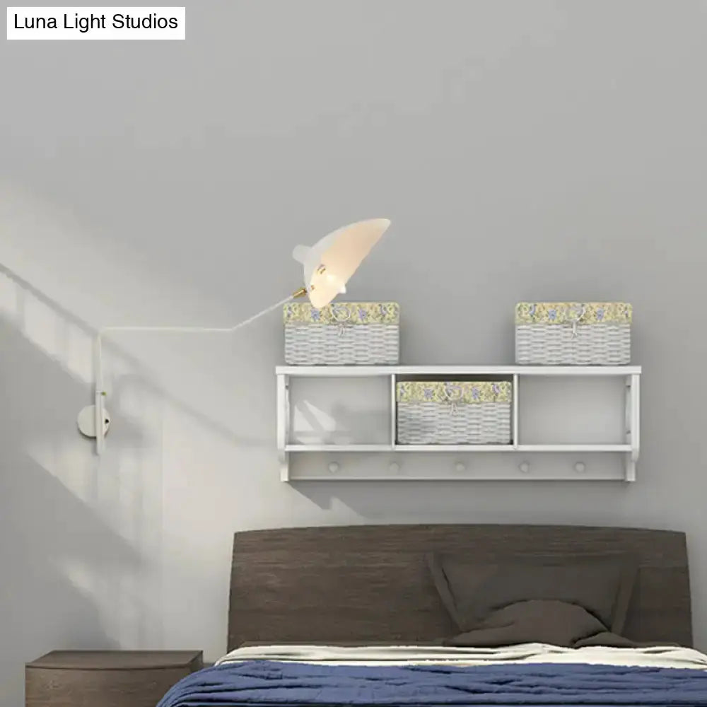 Modern white articulated wall sconce by Decorbites with adjustable arm over bed, baskets on Tampa Home & Garden Store